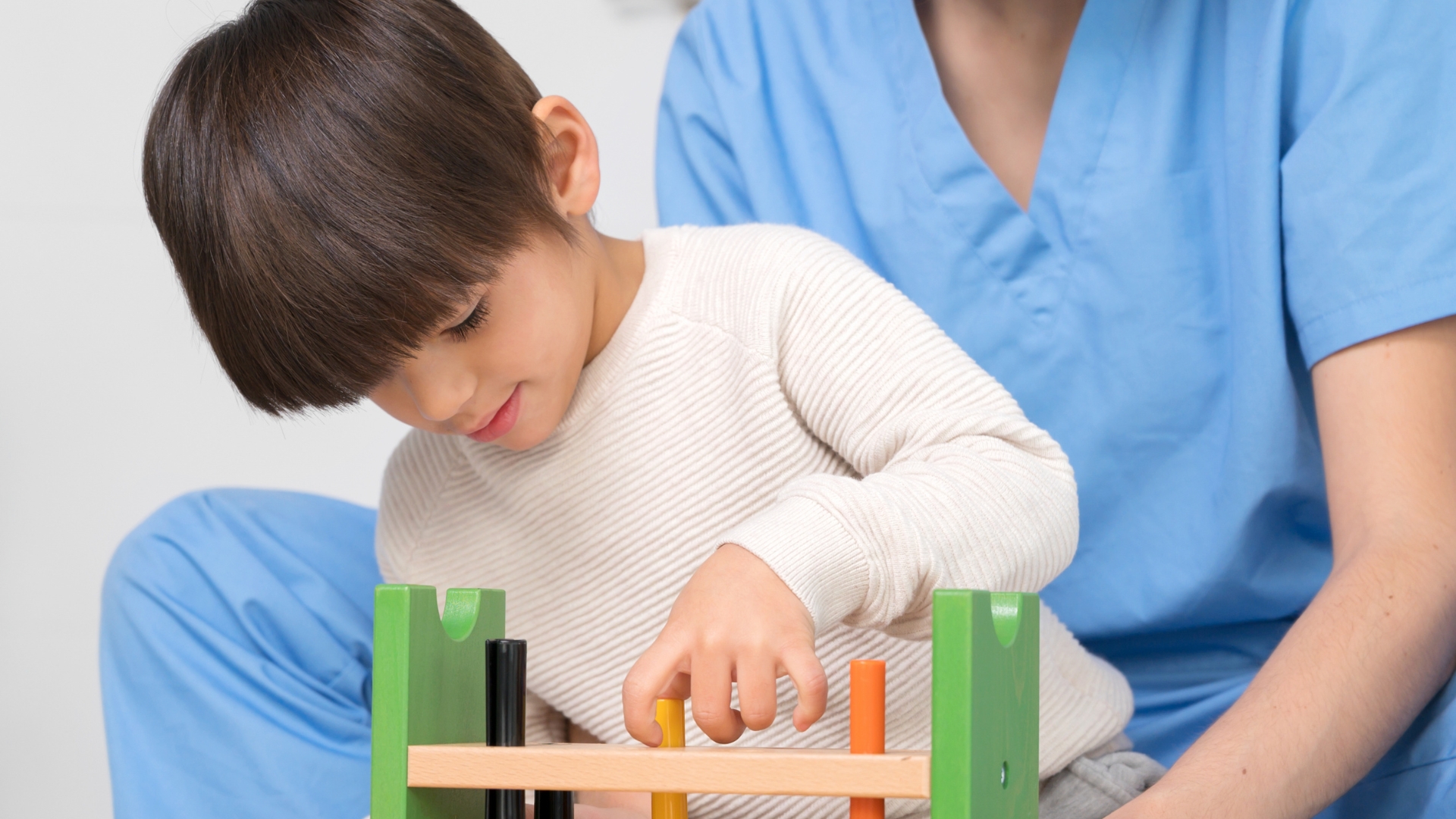 Pediatric occupational therapist evaluating a child's fine motor skills