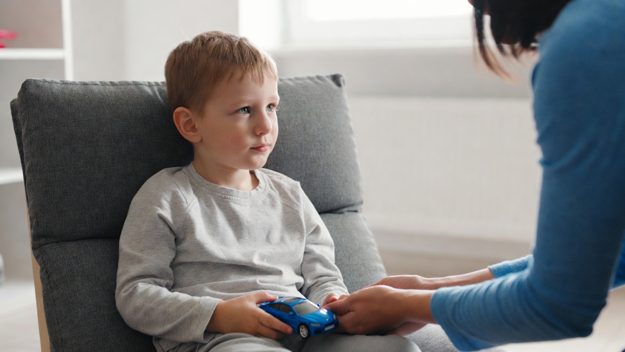 Parent practicing communication strategies with their toddler at home
