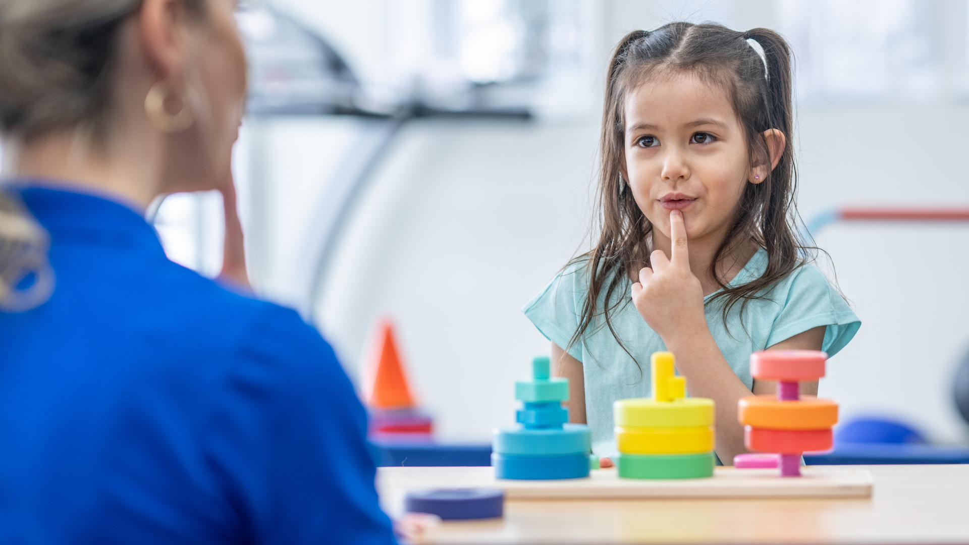 Pediatric speech therapist helping a child build fluent, confident speech