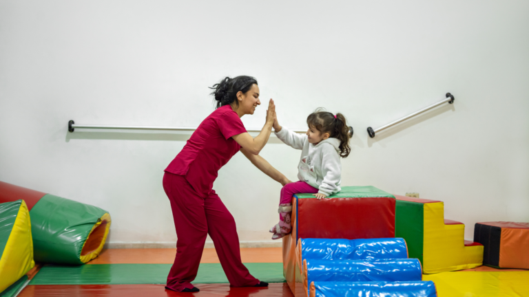 A young child and a pediatric occupational therapist working together on calming and self-regulation strategies.